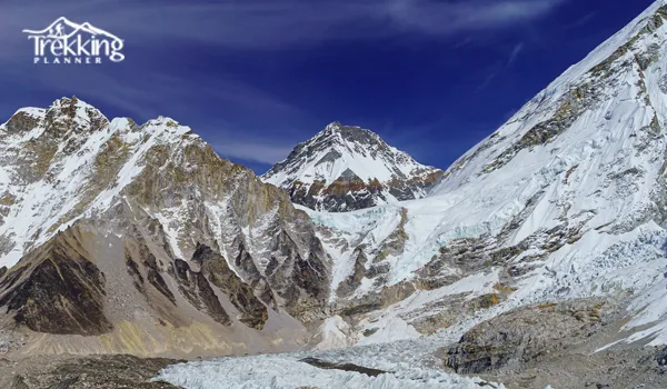 Trekkers walking toward Everest Base Camp during March under clear Himalayan skies.