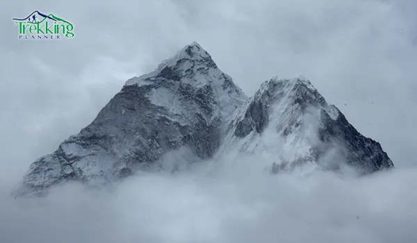 Trekkers walking along the Everest Base Camp trail in November surrounded by Himalayan peaks.