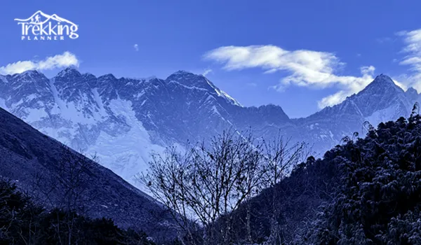 Successful climbers reaching the summit of Cholatse Peak in Nepal with panoramic Himalayan scenery.