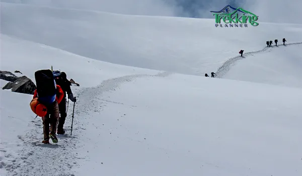 Group of trekkers enjoying mountain adventure with trekking planner in scenic alpine landscape