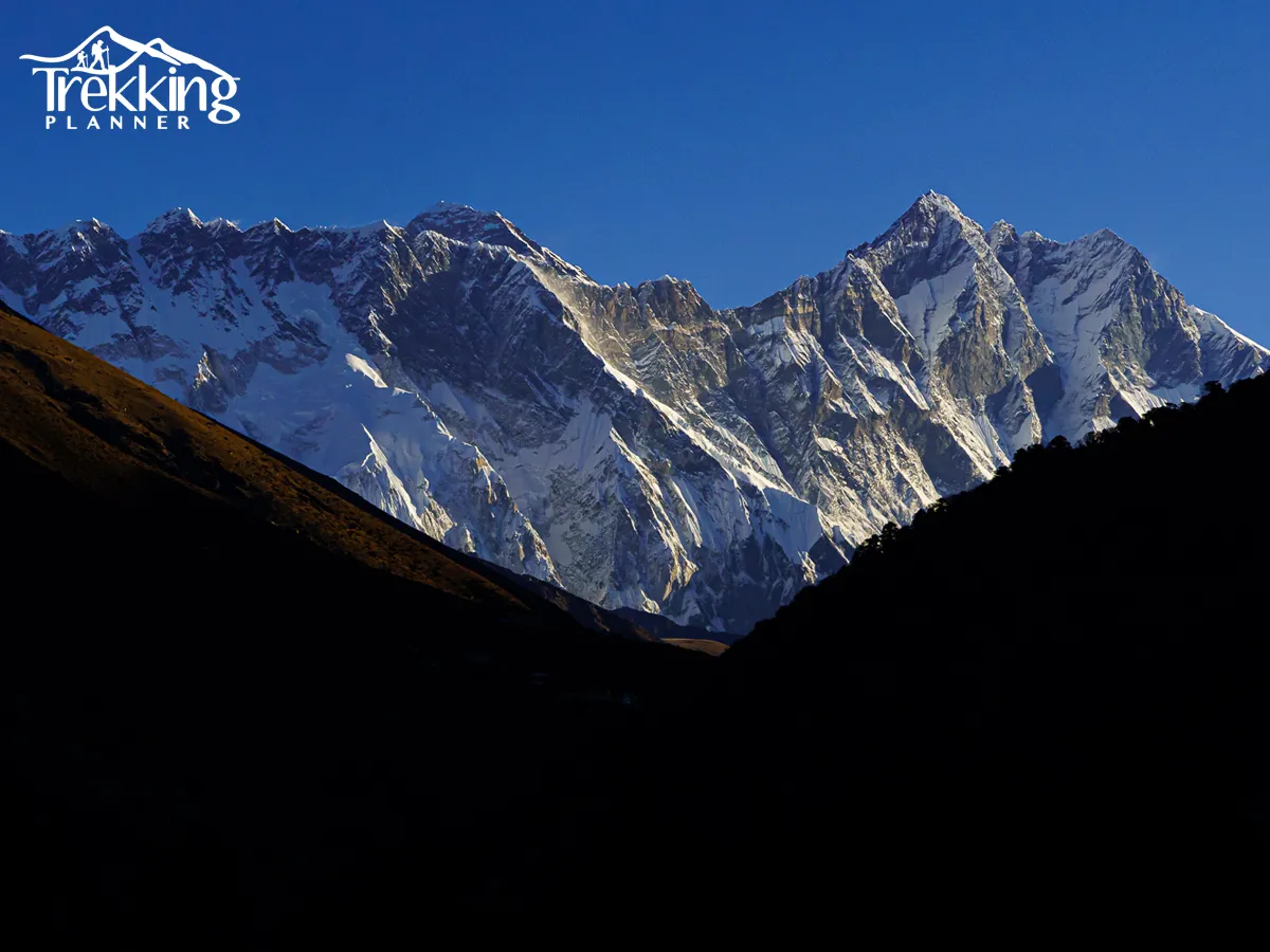 Sunset view of Ama Dablam peak glowing over Himalayan mountain range