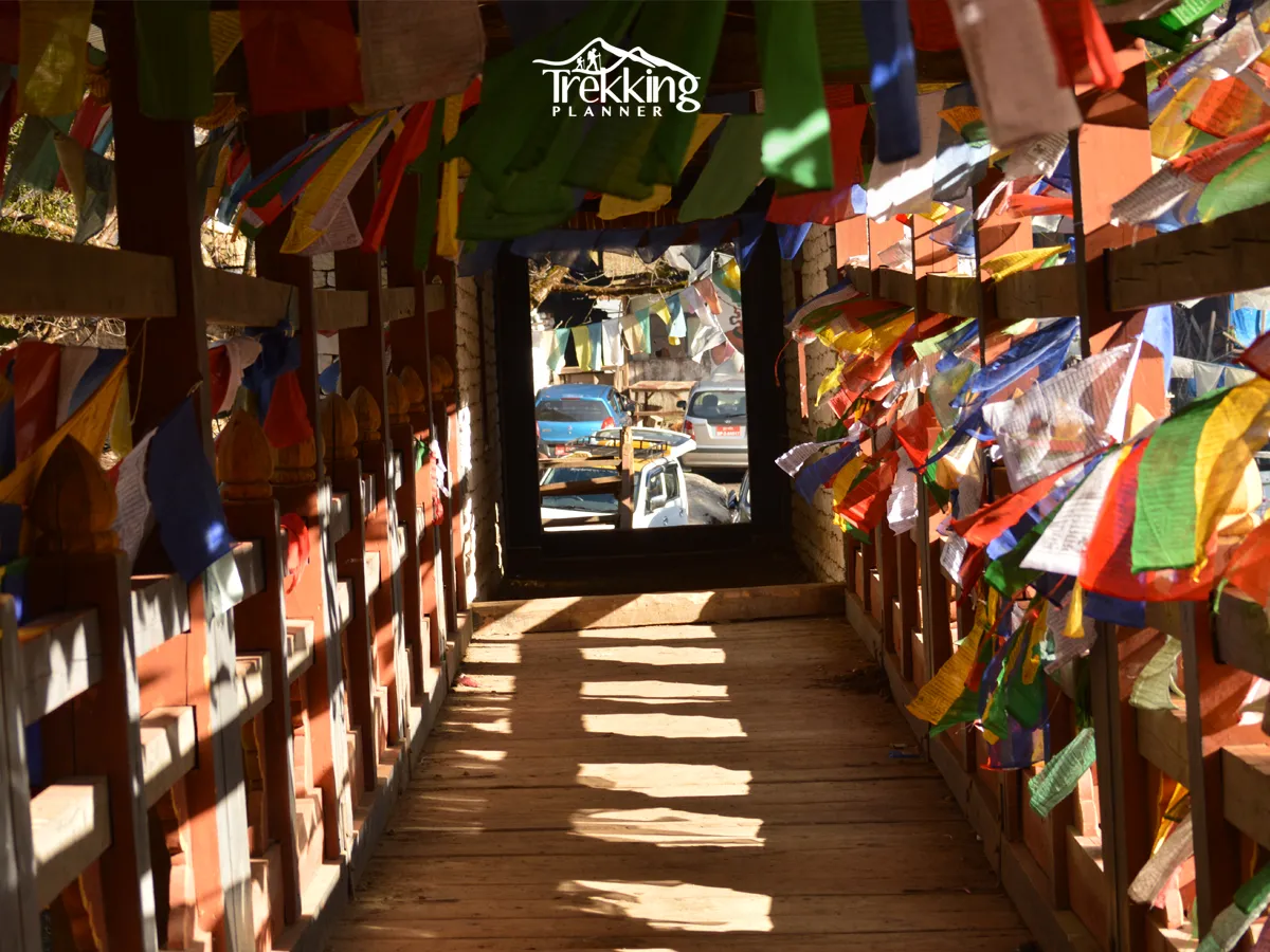 Colorful Buddhist prayer flags decorating a traditional walkway in Bhutan.