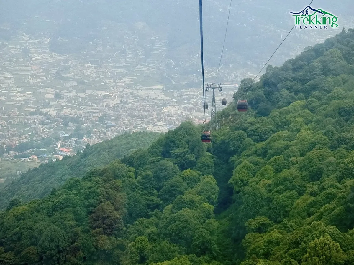 Visitors riding the Chandragiri Cable Car with panoramic Himalayan views on a Swayambhunath and Chandragiri day tour