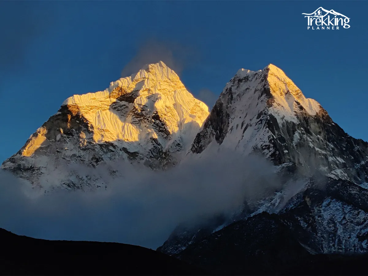 Base Camp Yoga Trek participants doing sunrise yoga with Himalayan mountains in background