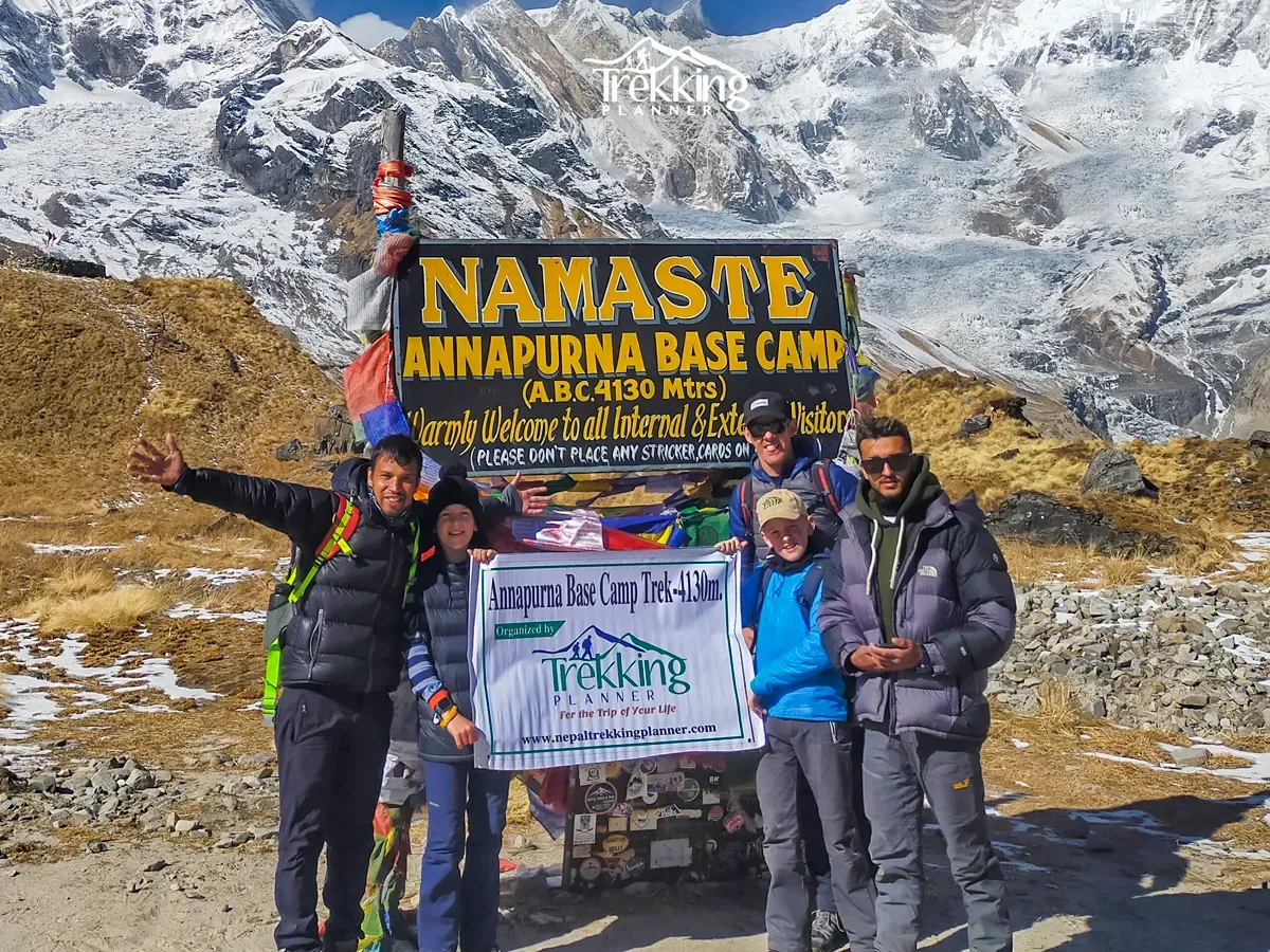 Family celebrating at Annapurna Base Camp during their family trekking adventure in Annapurna