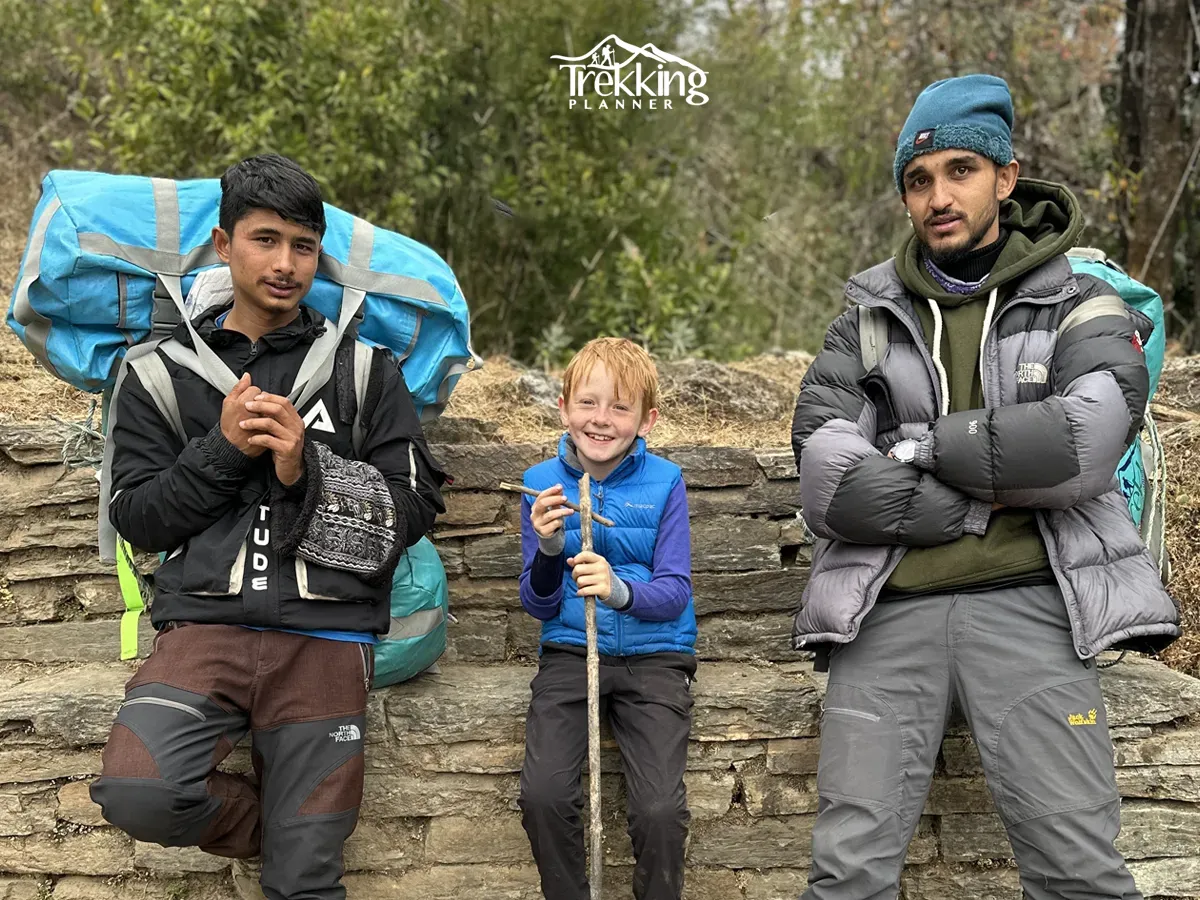 Young trekker with experienced local guides during a family trekking adventure in the Annapurna region