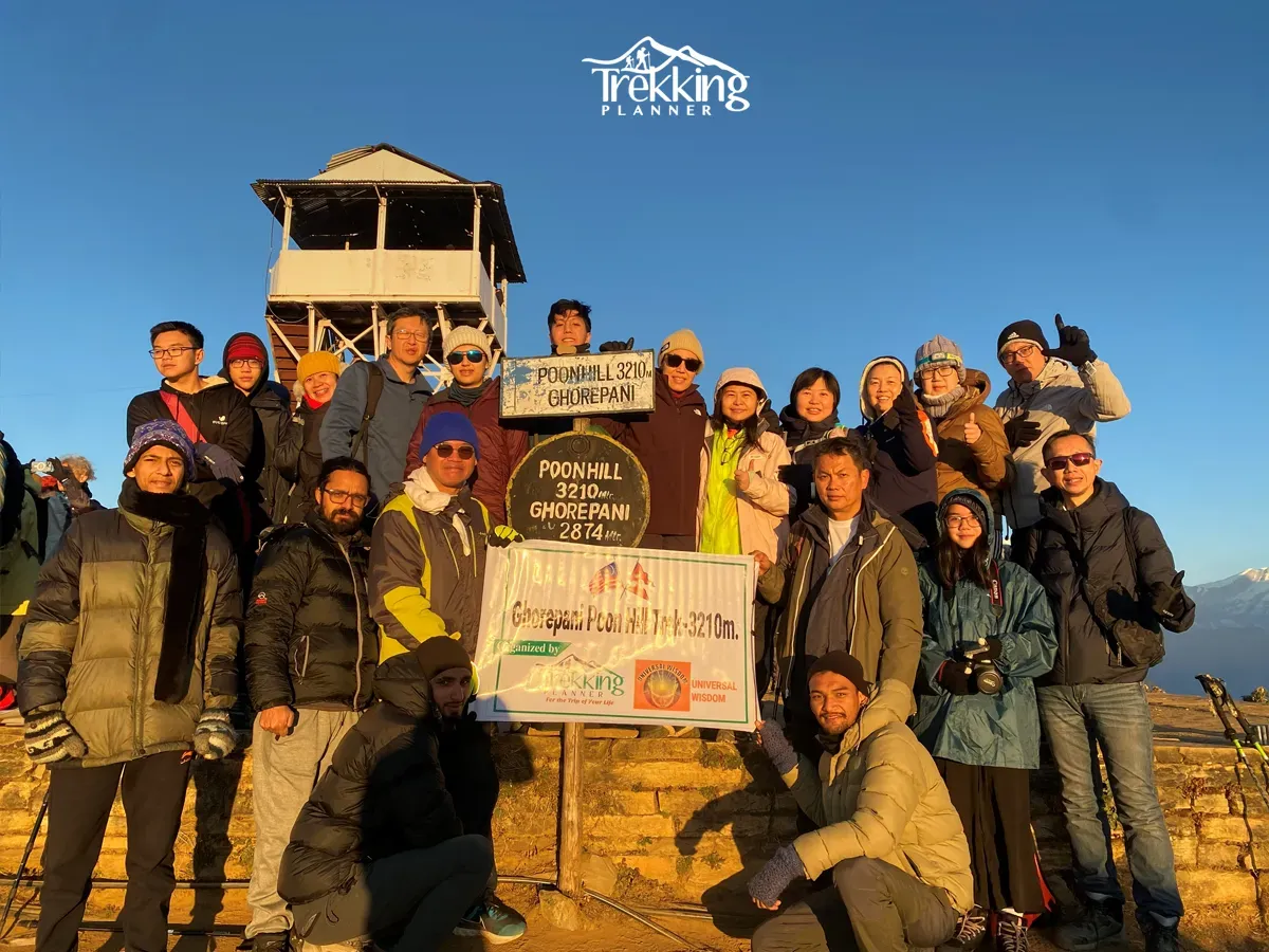 Group of trekkers enjoying the sunrise at Poon Hill during the Ghorepani Poon Hill Trek in Nepal