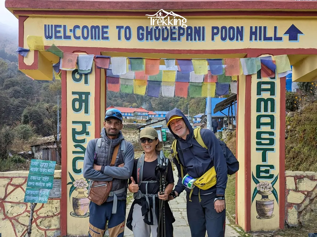 Trekkers posing at the welcome gate before starting the Ghorepani Poon Hill Trek in Ghorepani, Nepal