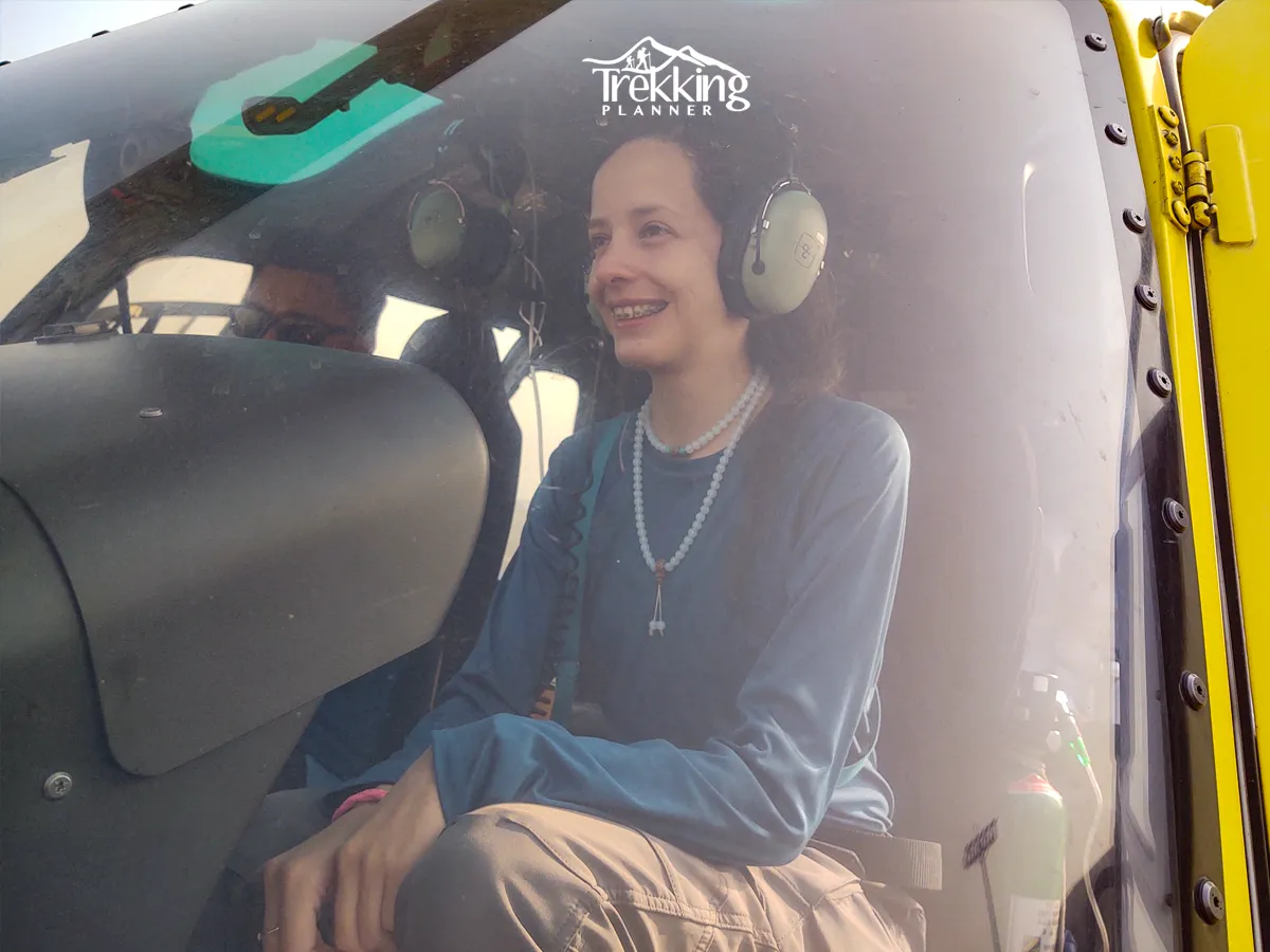 Helicopter ride from Kathmandu to Lukla with a traveler enjoying scenic Himalayan views before the Everest trek.