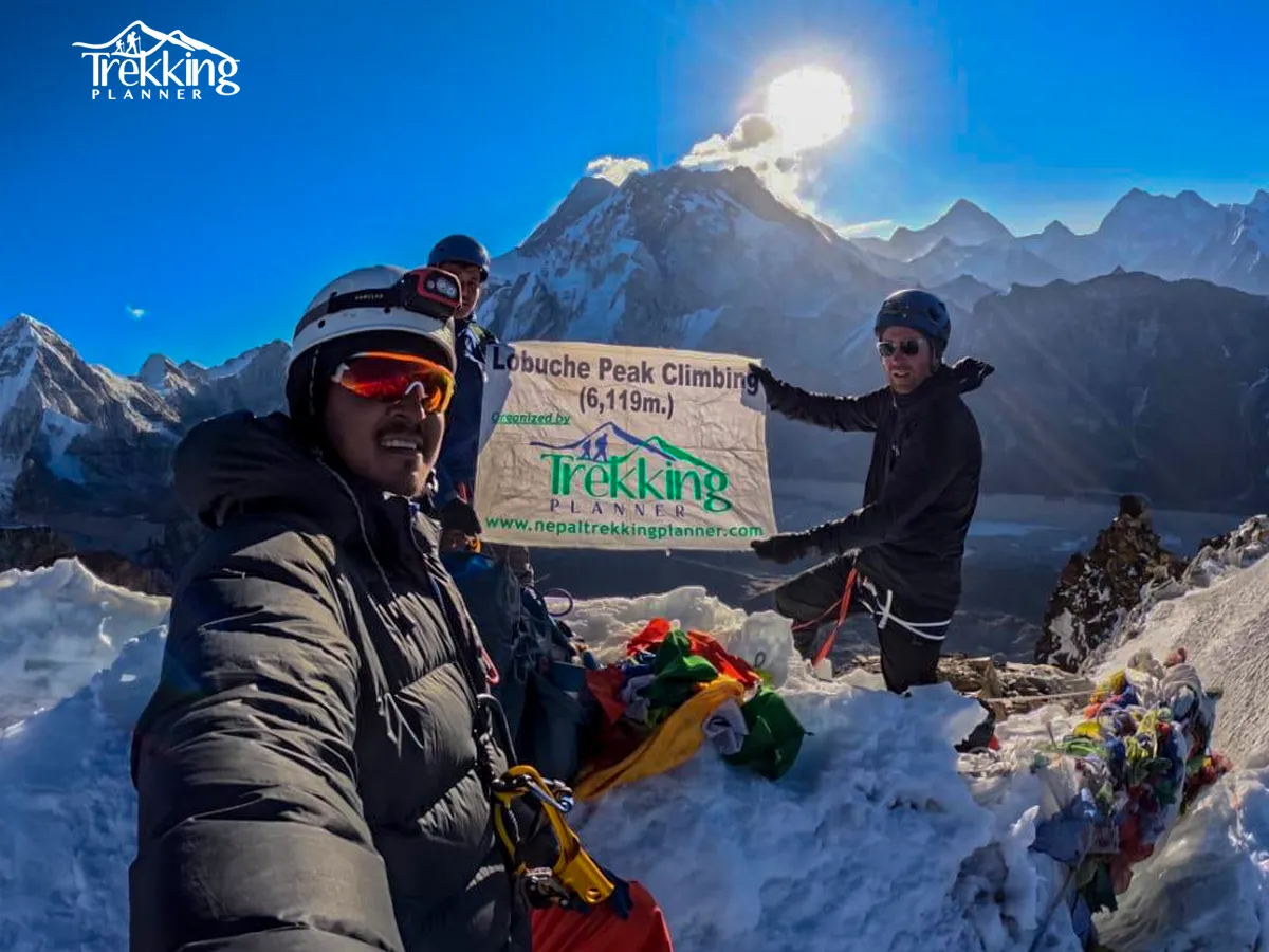 Mountaineers reaching the summit ridge of Island Peak with dramatic Himalayan scenery