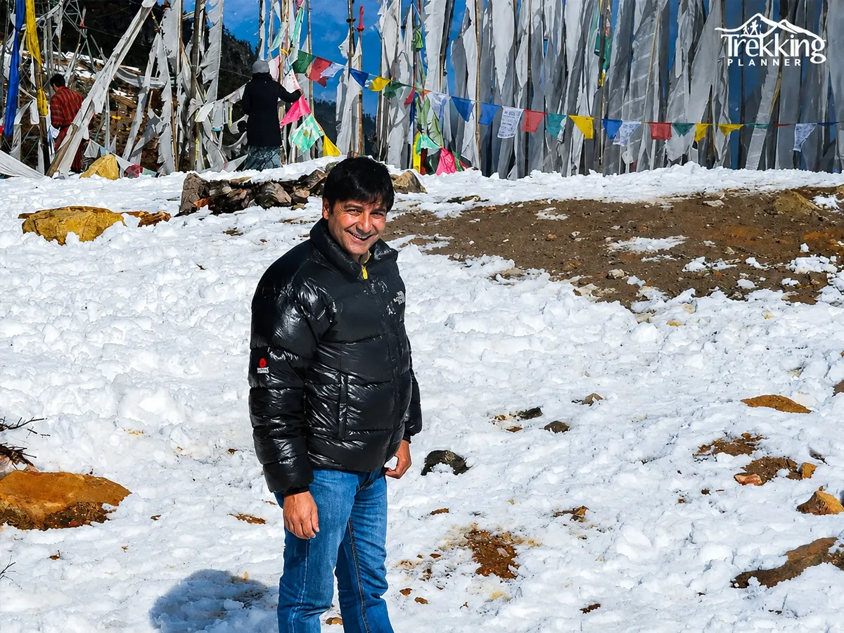 Trekker enjoying snow at Jangothang Base Camp on the Jomolhari Trekking route