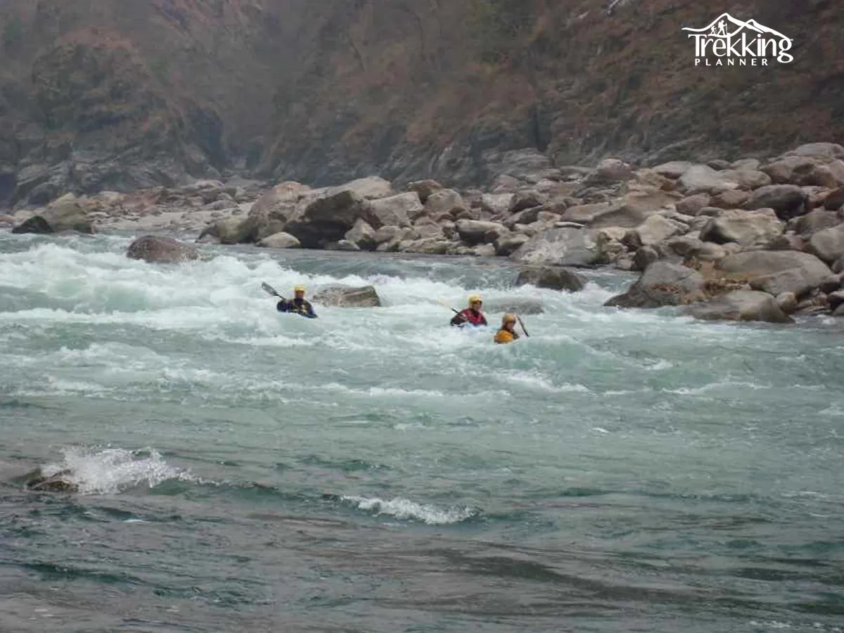 Rafting through scenic rapids on the Kali Gandaki River in Nepal surrounded by Himalayan cliffs