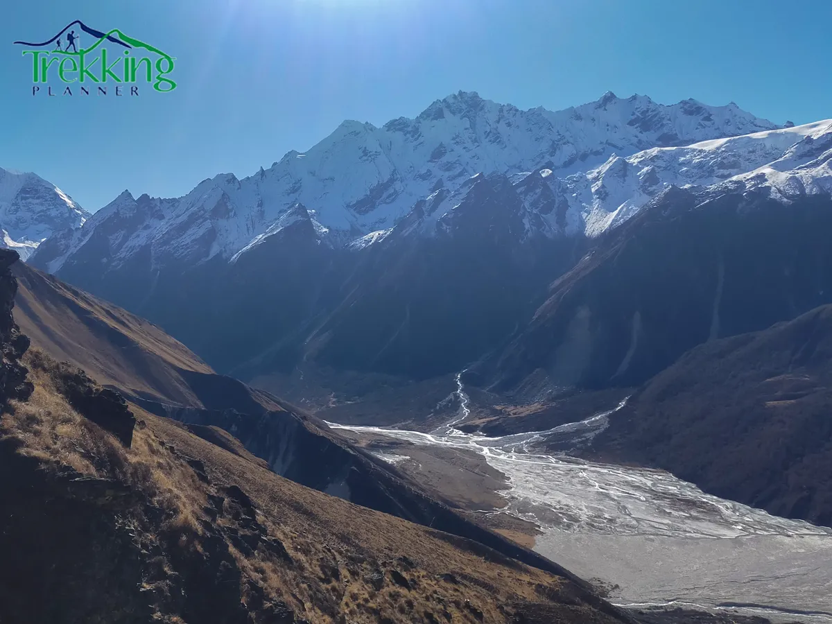 Trekkers walking slowly through Khumbu village on an easy Everest trekking trail with traditional houses