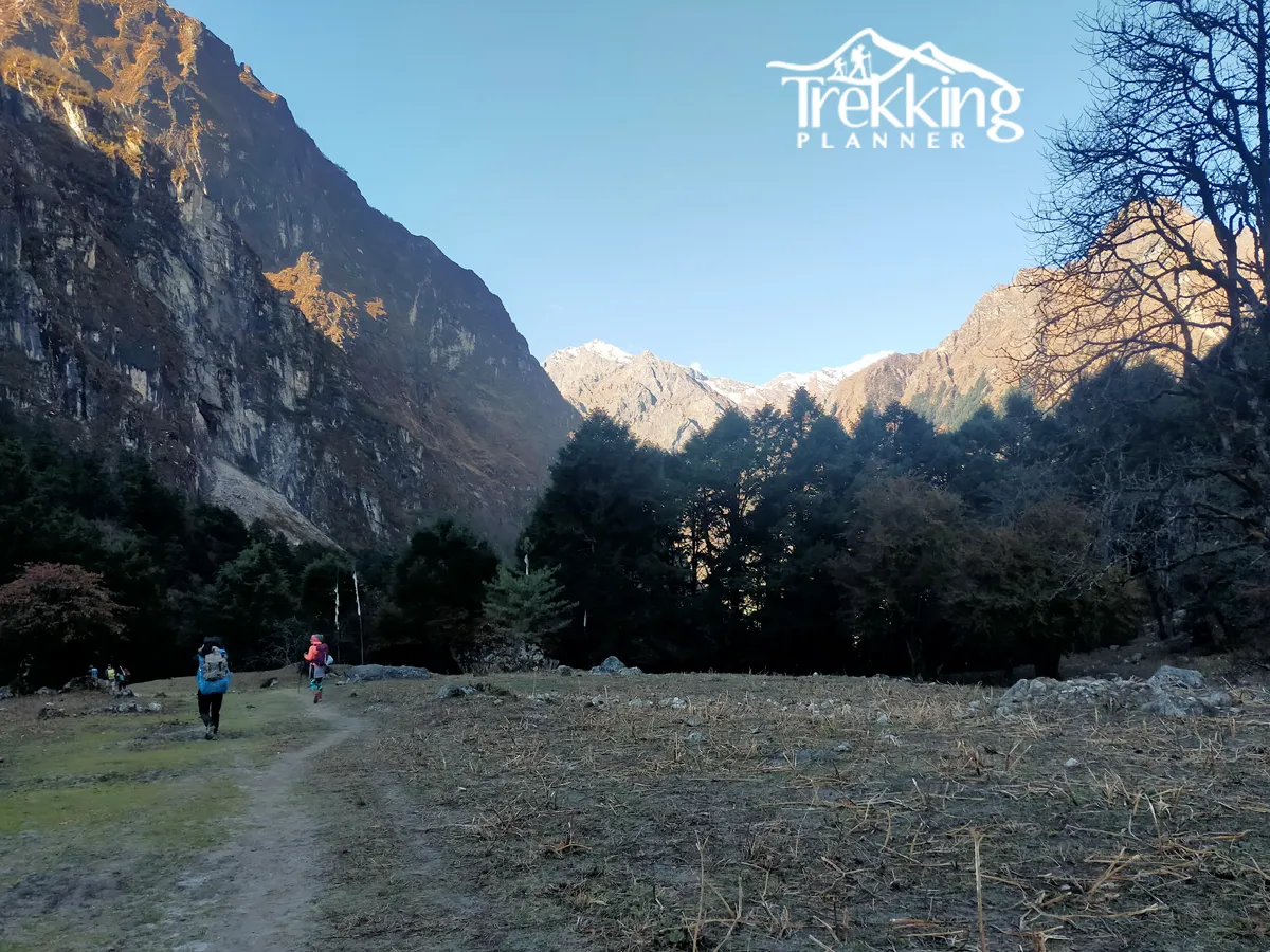 Trekkers crossing a suspension bridge on the Manaslu Circuit Short Trek.