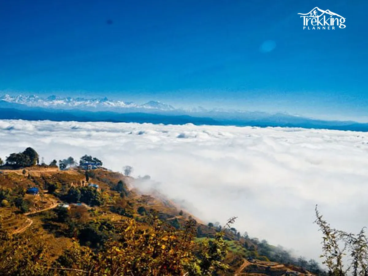 Hikers walking along the scenic Nagarkot to Changu Narayan trail through forests and traditional villages.