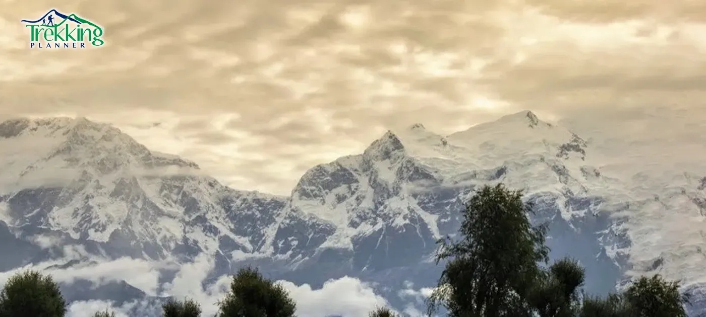 Traditional Nepali village homestay surrounded by mountains and greenery in rural Nepal