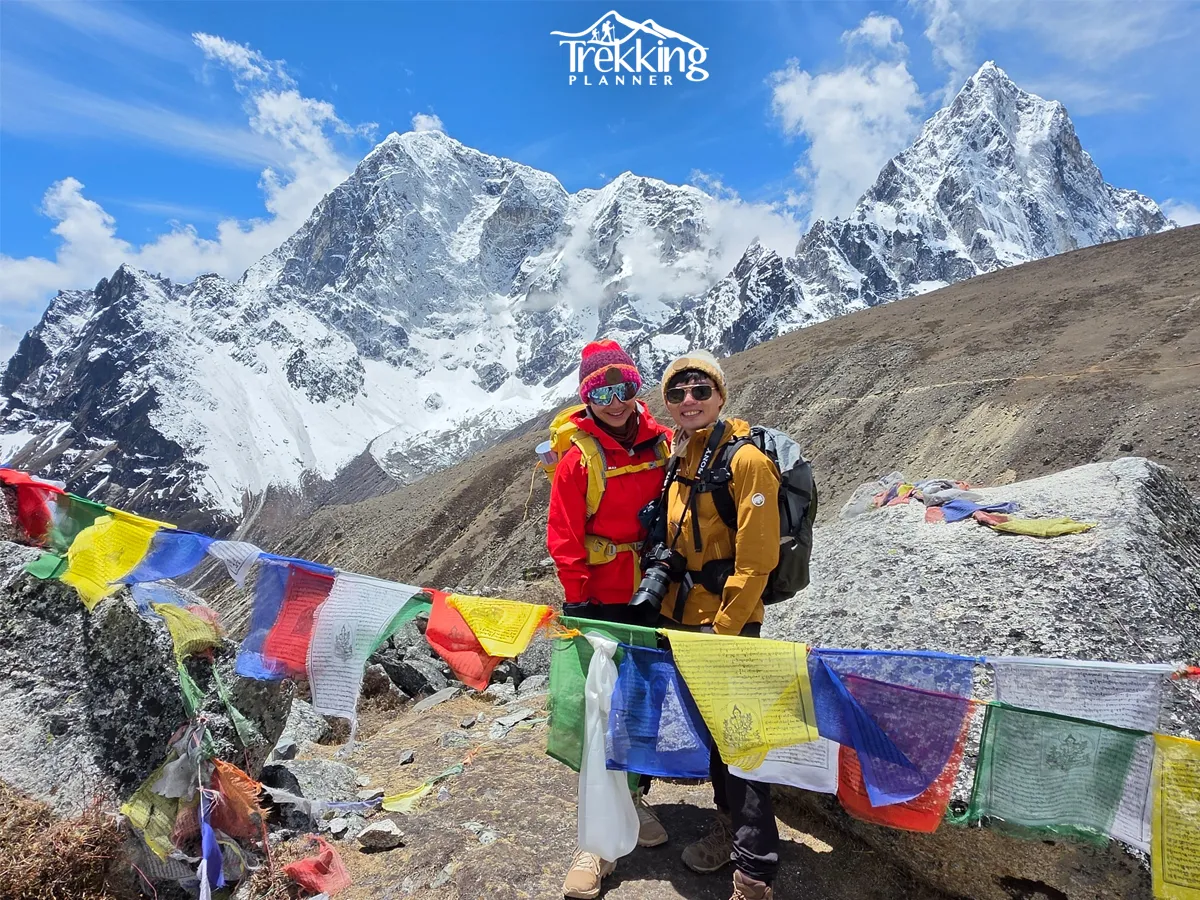 Happy trekkers enjoying panoramic views of Mount Everest, Nuptse, and Ama Dablam during the Rapid Everest Base Camp Trek.