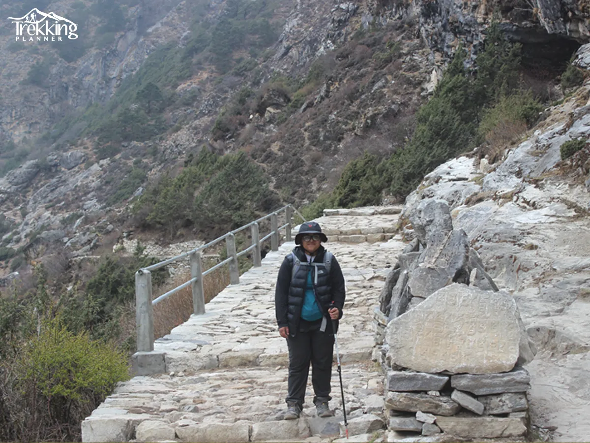 Senior citizens trekking towards Everest Base Camp with views of Mount Everest and surrounding peaks.