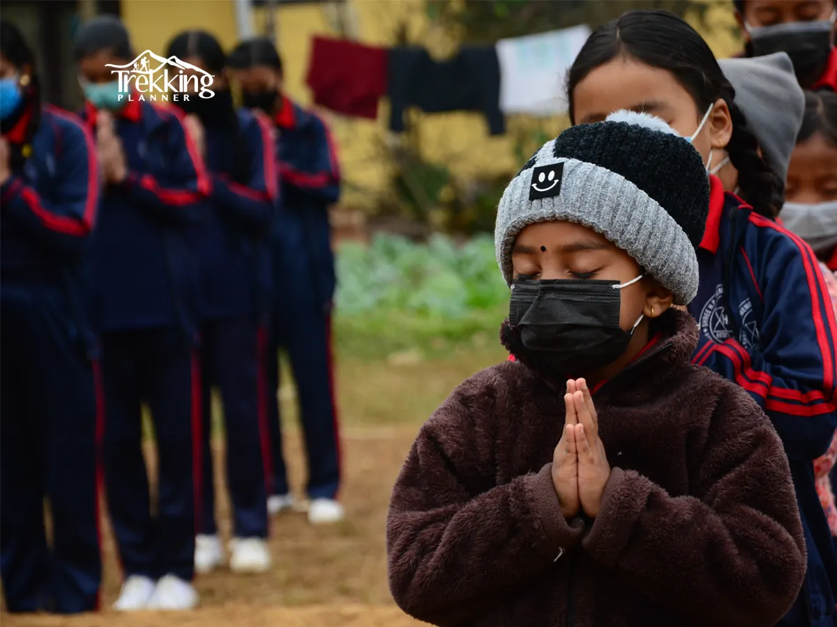 Volunteers supporting Nepalese school students with educational materials in rural Nepal