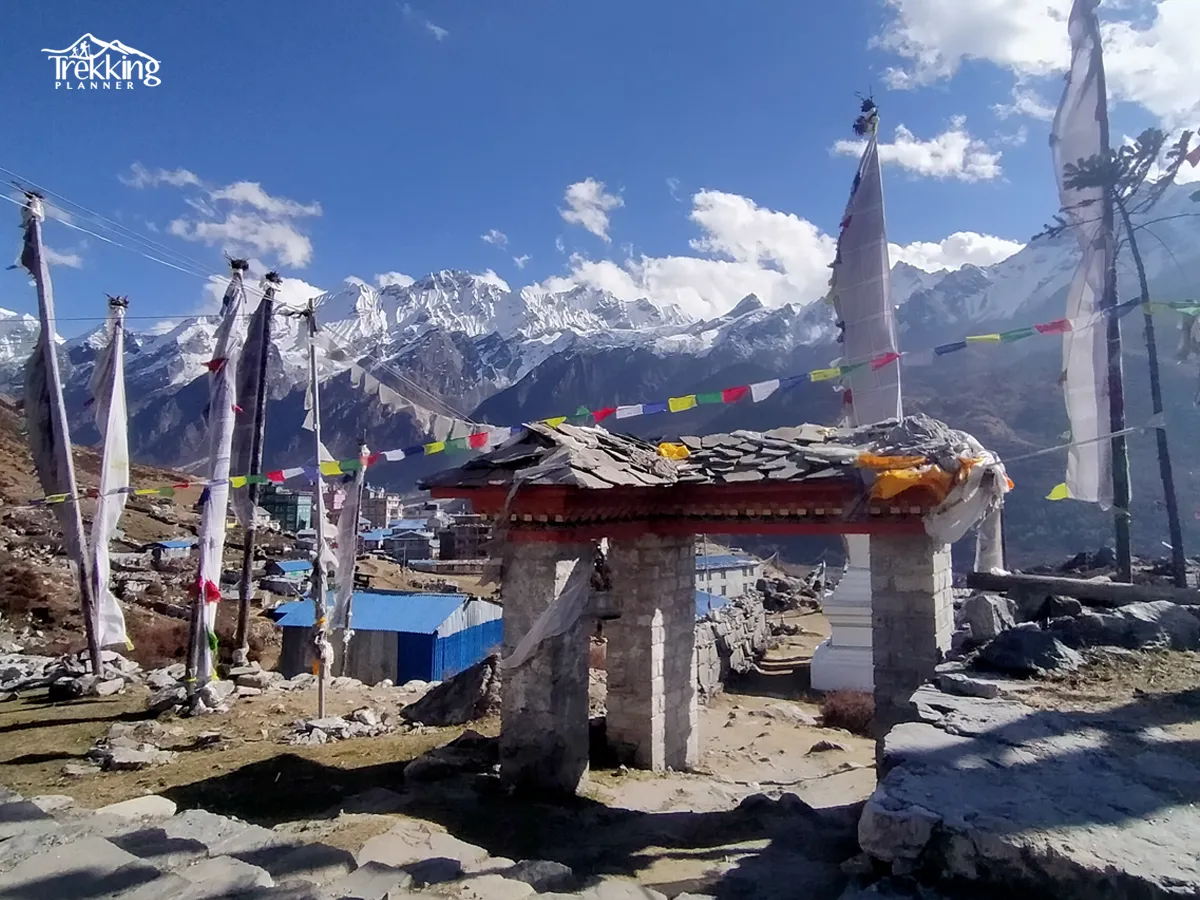 Traditional stone houses and colorful prayer flags on Tamang Heritage Trail Trekking in Nepal