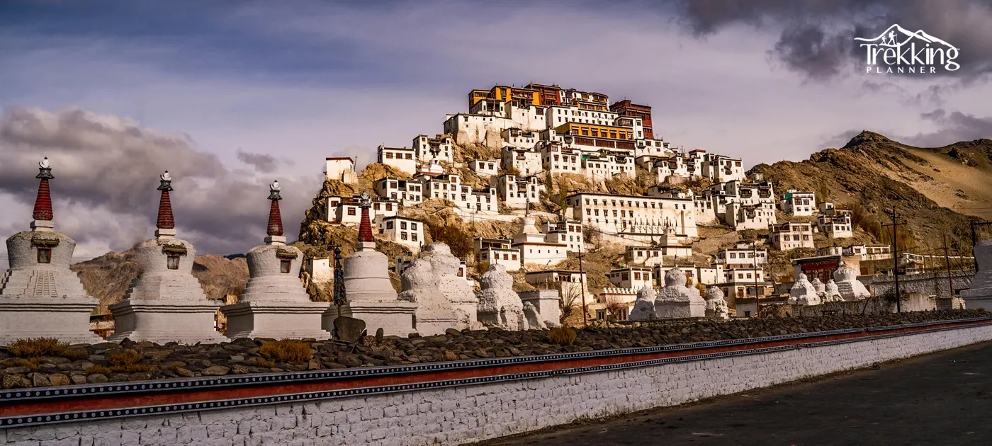 Scenic landscape of a Tibetan monastery with striking architecture against a dramatic sky