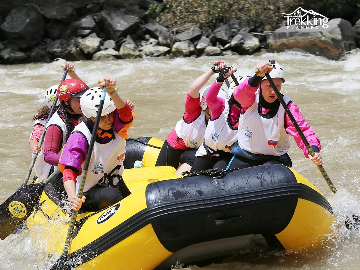 Group of tourists rafting together on Trishuli River surrounded by scenic hills of Nepal