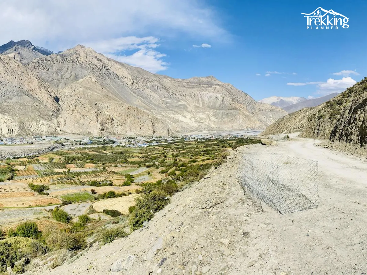 Off-road motorbike riding on dusty cliffside trail during Upper Mustang bike tour in Nepal