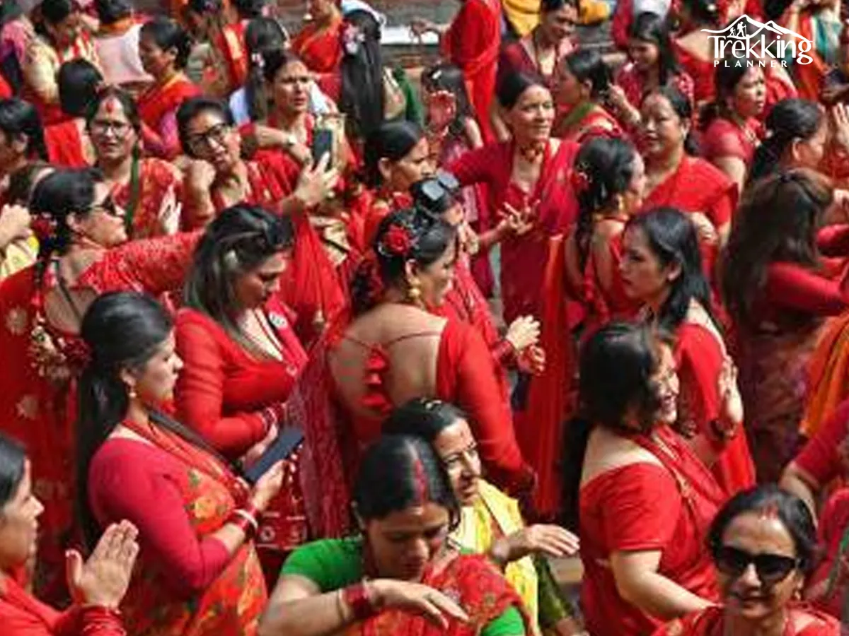 Women in red sarees dancing during Teej festival celebration in Nepal