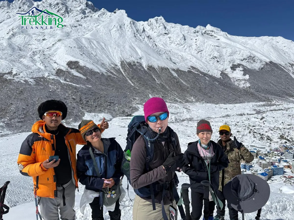 Climbers ascending Yala Peak in the Langtang region of Nepal with snow-covered Himalayan peaks in the background