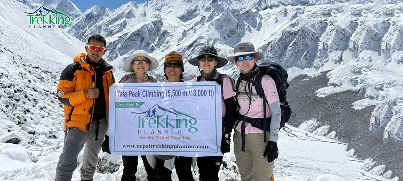 Trekking group crossing snowy ridge during Yala Peak climbing expedition in Nepal
