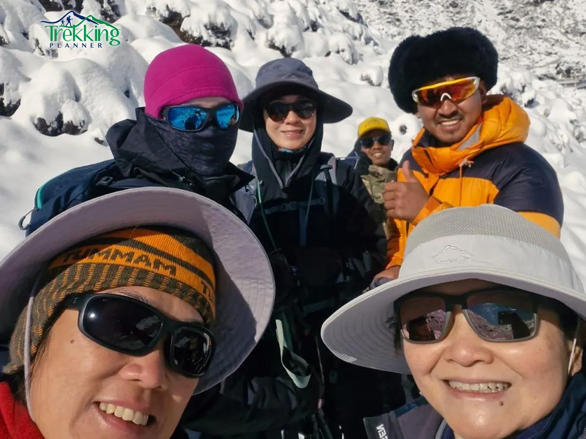 Trekkers standing on the summit of Yala Peak enjoying panoramic views of Langtang Lirung and surrounding mountains