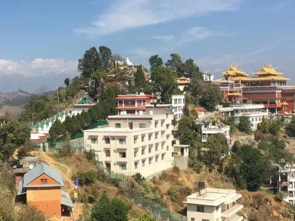 Hikers walking along the scenic trail from Dhulikhel to Namobuddha with Himalayan mountain views