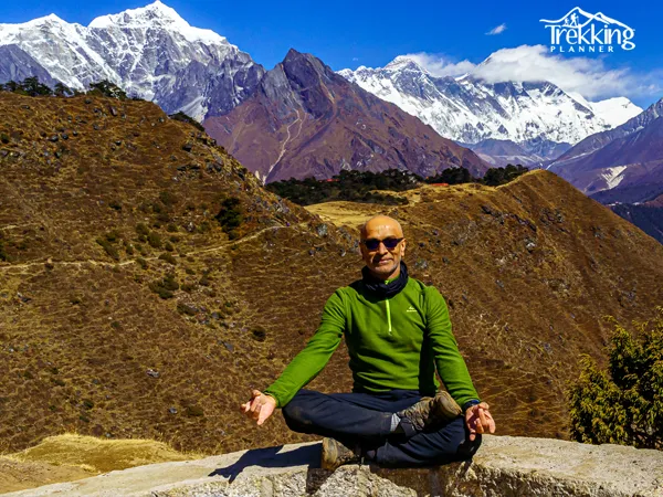 Scenic Everest Base Camp Yoga Trek landscape with trekkers doing yoga overlooking snow capped peaks