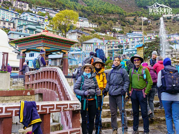 Senior trekkers enjoying the Everest Base Camp trekking trail with Himalayan mountain views in Nepal.