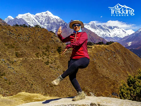 Group trekking along Himalayan trail with scenic Everest panorama during yoga trek adventure