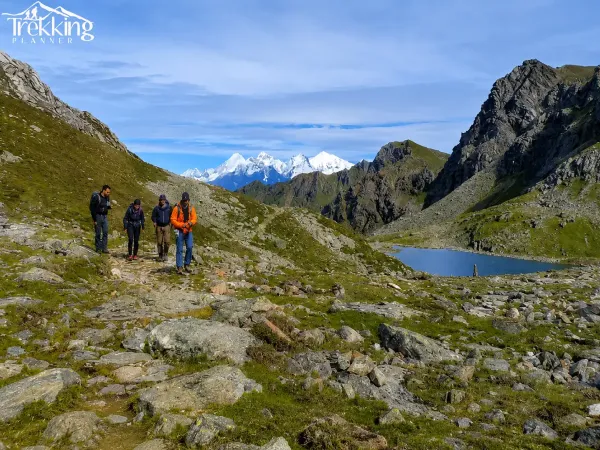 Alpine Hikers Among Snowy Peaks