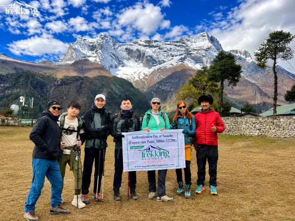 Group Trekking Portrait Beneath Snowy Peaks