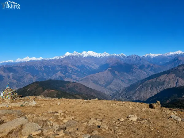 Prayer Flag Cairn Before Snowy Peaks