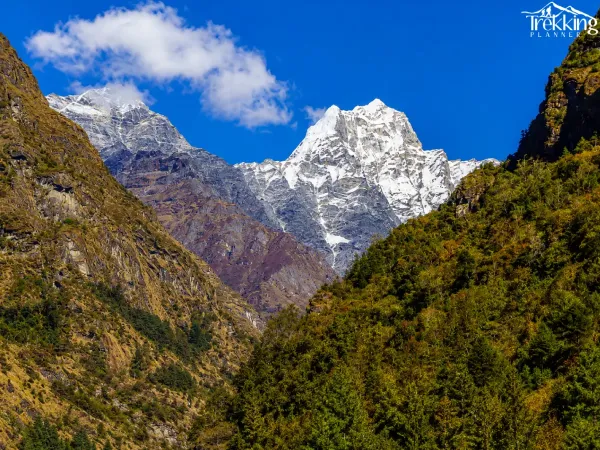 Snowy Peak Above The Rugged Valley