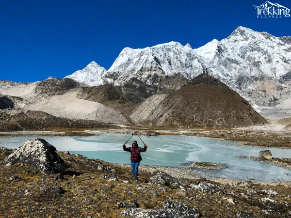 Triumphant Hiker Beneath Snowy Peaks