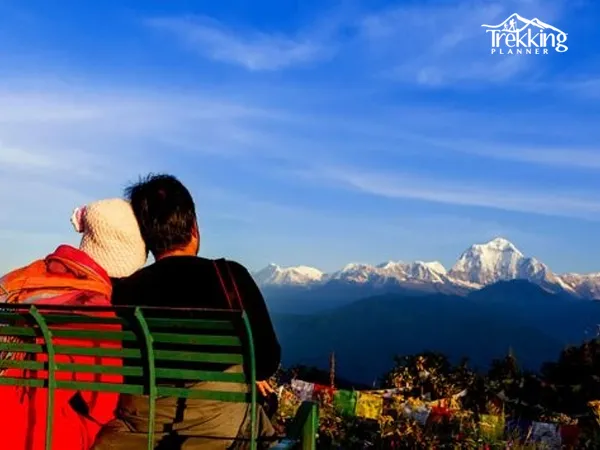 Couple watching sunrise over the Himalayas in Nagarkot during a honeymoon holiday in Nepal