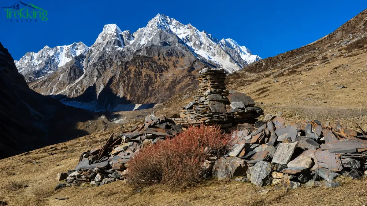 alpine-cairn-beneath-snowy-peaks