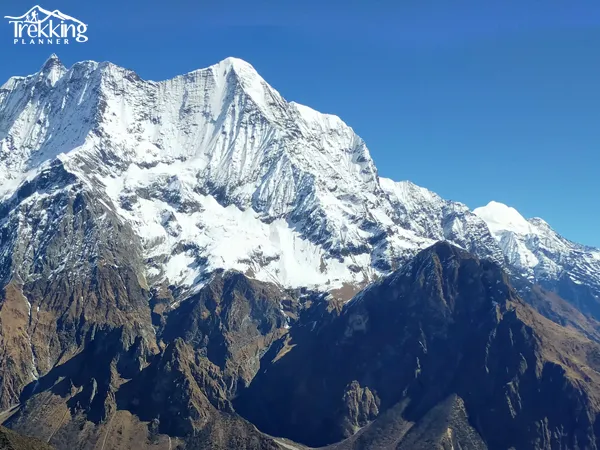 Snow-covered trail of Manaslu Circuit Trekking leading toward Larke La Pass with Himalayan peaks in background