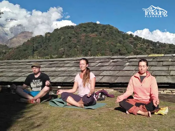 Meditation tour in Nepal with participants meditating in the Himalayas surrounded by mountains and peaceful nature