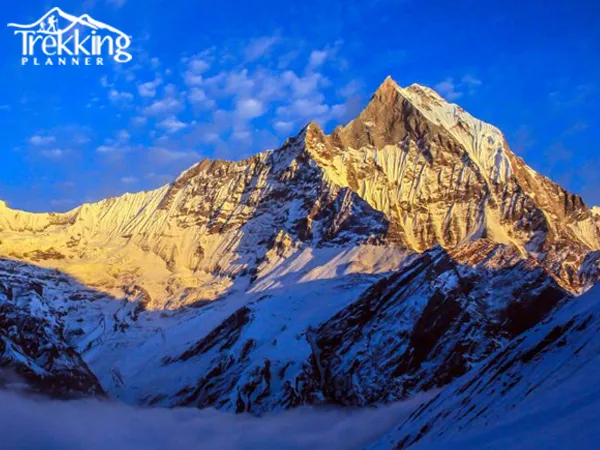 North Annapurna Base Camp Trek panoramic view of snow-covered Annapurna peaks with trekking trail and hikers walking through alpine landscape in Nepal