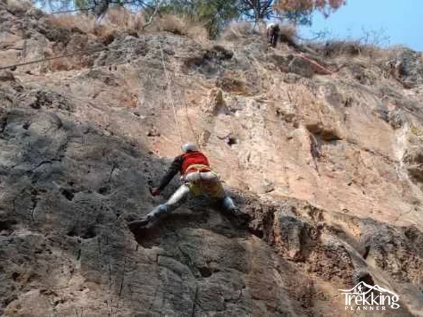 Rock climber ascending a challenging outdoor climbing route near Kathmandu