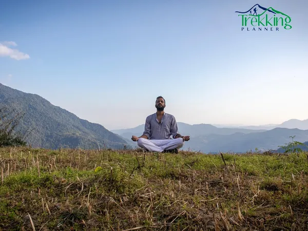 Silent yoga retreat in Nepal with participants meditating facing the Himalayas at sunrise