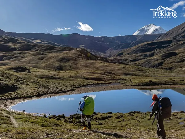 Upper Mustang Damodar Lake Trek trail passing through rugged Himalayan desert landscape with mountains in background